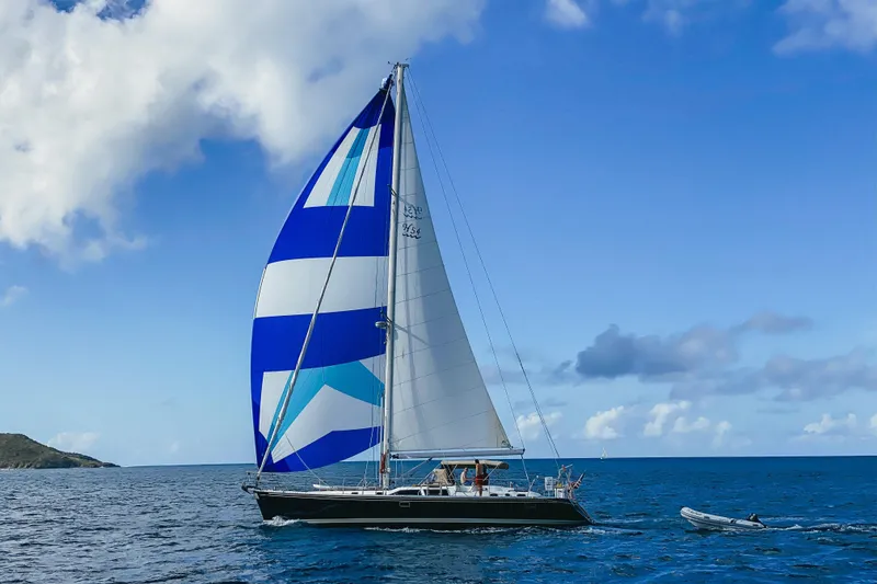 Slide: The Image of Sailing yacht Hylas 54' (1998) with blue and white spinnaker on open sea. - 30