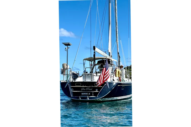 Slide: The Image of Sailing yacht Hylas 54', 1998 model, with American flag, on blue water. - 5