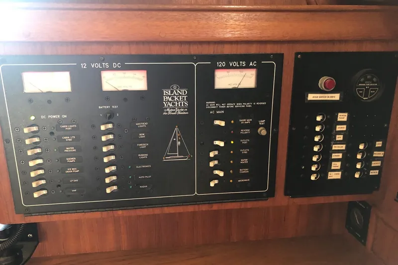 Slide: The Image of Electrical control panel of a 1997 Island Packet 350 yacht, featuring DC and AC systems. - 13