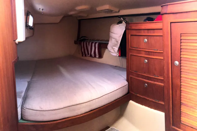 Slide: The Image of Cozy aft double berth cabin interior of 1997 Island Packet 350 sailboat with wooden storage drawers. - 15