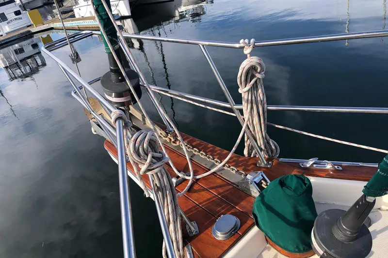 Slide: The Image of Deck view of a 1997 Island Packet 350 sailboat with ropes and polished wood. - 17