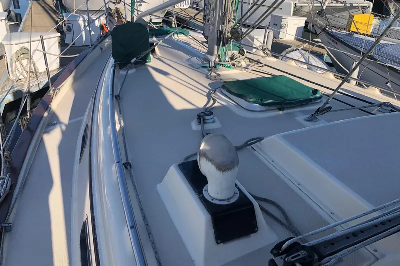 Slide: The Image of Deck view of a 1997 Island Packet 350 sailboat, featuring rigging and hatches. - 19