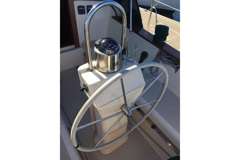 Slide: The Image of Steering wheel and compass of a 1997 Island Packet 350 sailboat. - 23