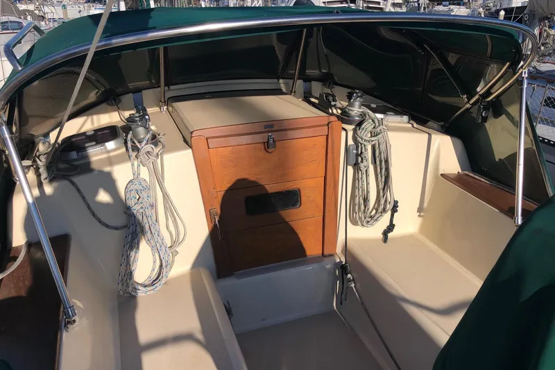 Slide: The Image of 1997 Island Packet 350 sailboat cockpit with ropes and wooden hatch. - 28