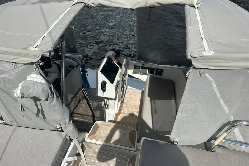 Slide: The Image of 2019 Fountaine Pajot 47 yacht cockpit with canopy and seating, overlooking water. - 15
