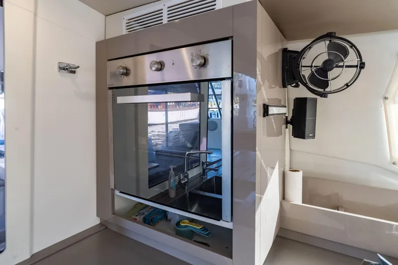 Slide: The Image of Modern kitchen area in 2019 Fountaine Pajot 47 yacht with oven and fan. - 22