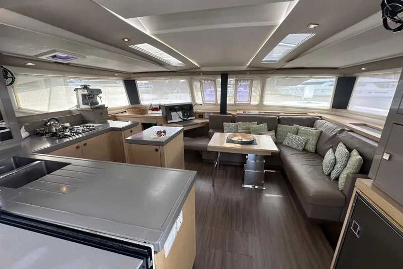Slide: The Image of Luxurious interior of 2019 Fountaine Pajot 47 catamaran with modern kitchen and cozy seating area. - 25