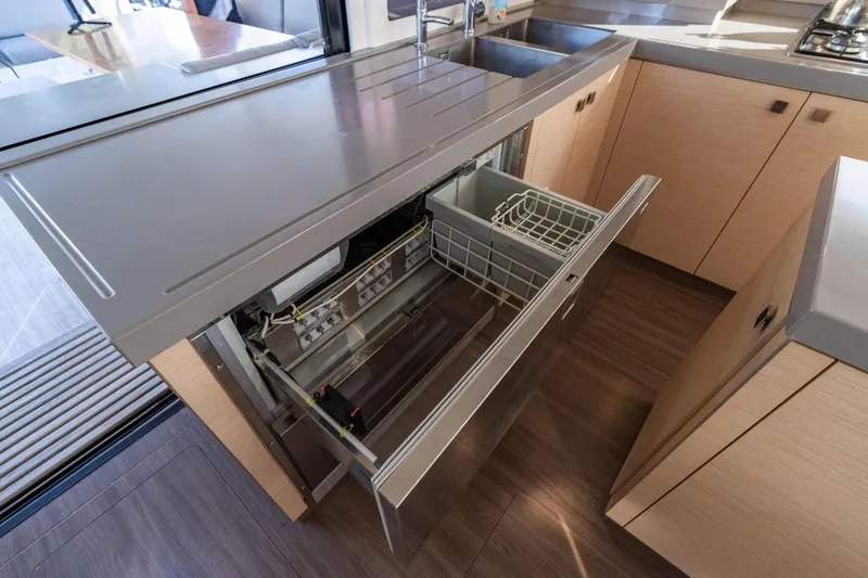 Slide: The Image of Modern kitchen in 2019 Fountaine Pajot 47 yacht with open dishwasher drawer. - 28