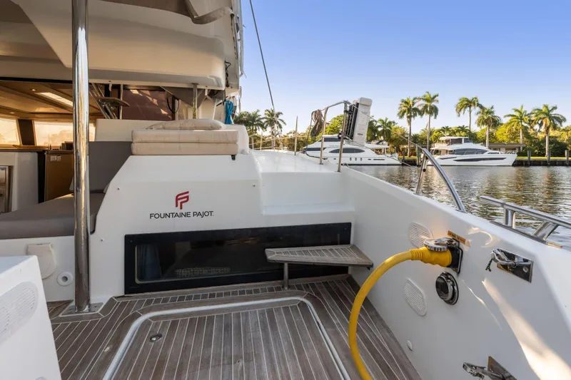 Slide: The Image of 2019 Fountaine Pajot 47 yacht deck with marina view and palm trees. - 41