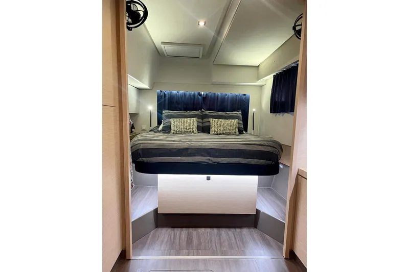 Slide: The Image of Luxurious bedroom interior of 2019 Saona 47 yacht with modern design and cozy bedding. - 47