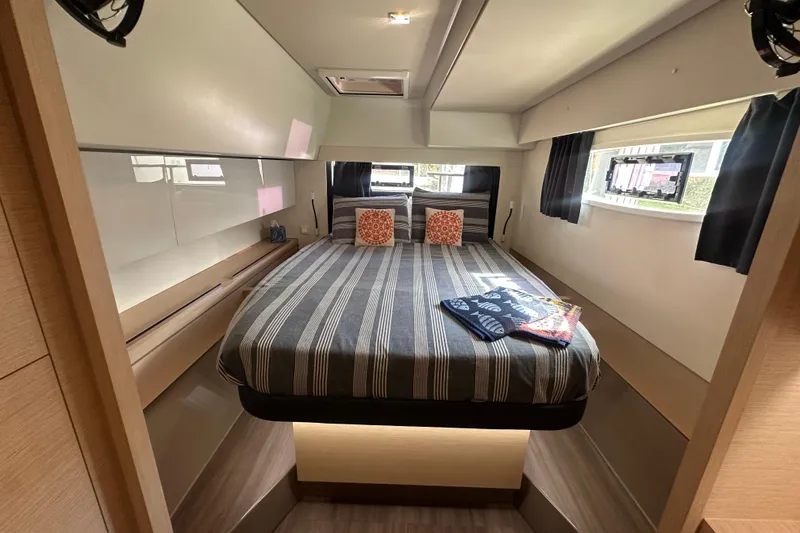 Slide: The Image of Luxurious cabin interior of 2019 Fountaine Pajot 47 yacht with striped bedding. - 48