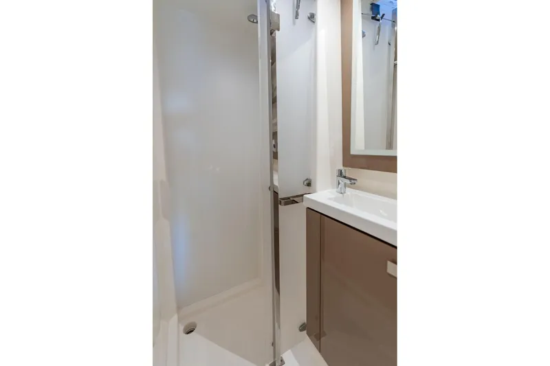 Slide: The Image of Modern bathroom interior on 2019 Fountaine Pajot 47 yacht, featuring sleek shower and sink. - 53