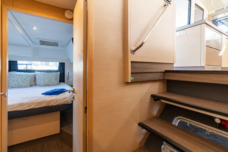 Slide: The Image of Interior of 2019 Fountaine Pajot 47 yacht, featuring cozy bedroom and modern staircase. - 65