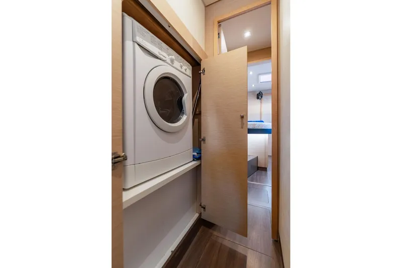 Slide: The Image of Laundry area inside 2019 Fountaine Pajot 47 yacht, featuring a washing machine. - 66