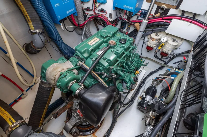 Slide: The Image of Engine room of 2019 Fountaine Pajot 47 catamaran with visible machinery and wiring. - 76