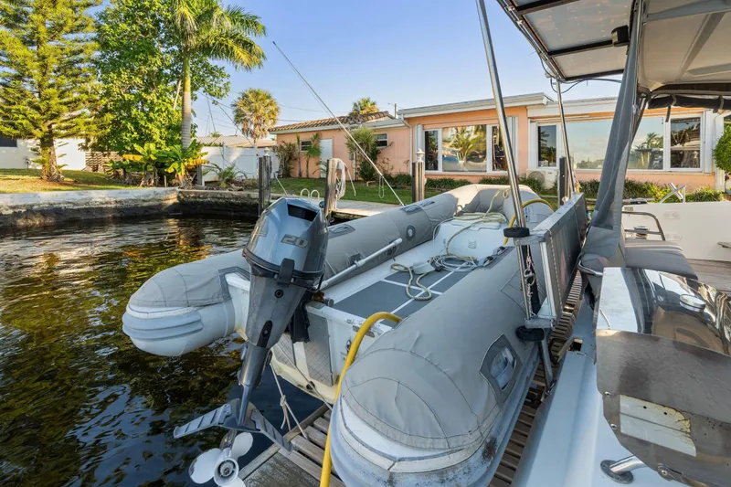 Slide: The Image of 2019 Fountaine Pajot 47 catamaran docked with inflatable boat and motor. - 81