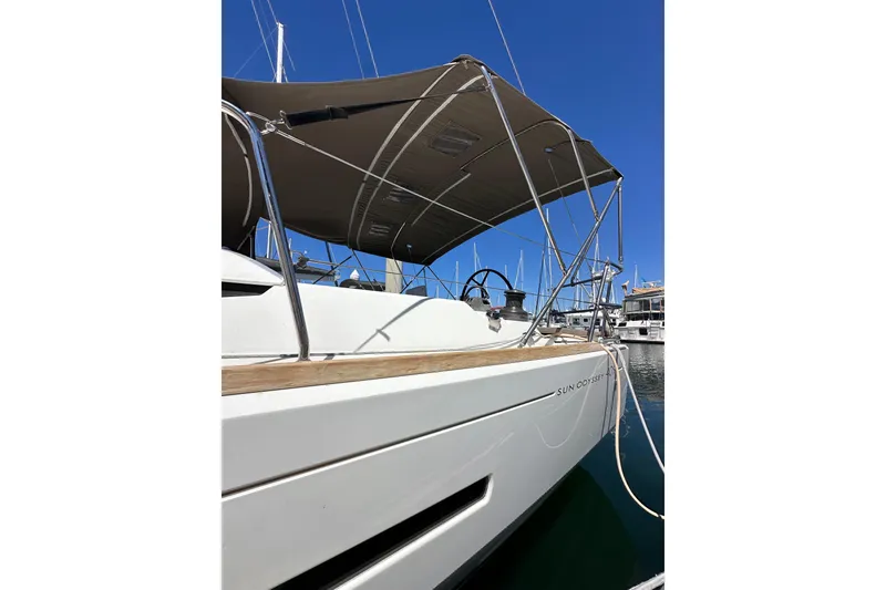 Slide: The Image of 2015 Jeanneau Sun Odyssey 409 sailboat docked, featuring sleek design and canopy. - 10
