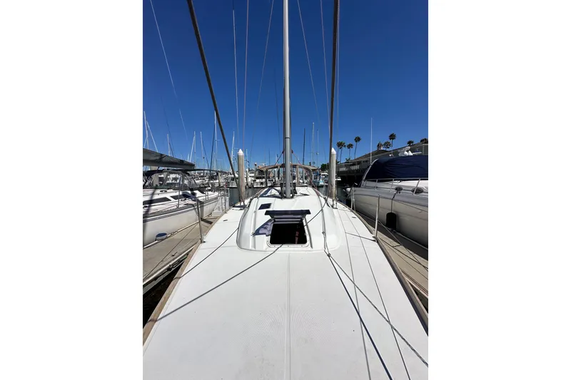 Slide: The Image of 2015 Jeanneau Sun Odyssey 409 sailboat docked in a marina under clear blue skies. - 20
