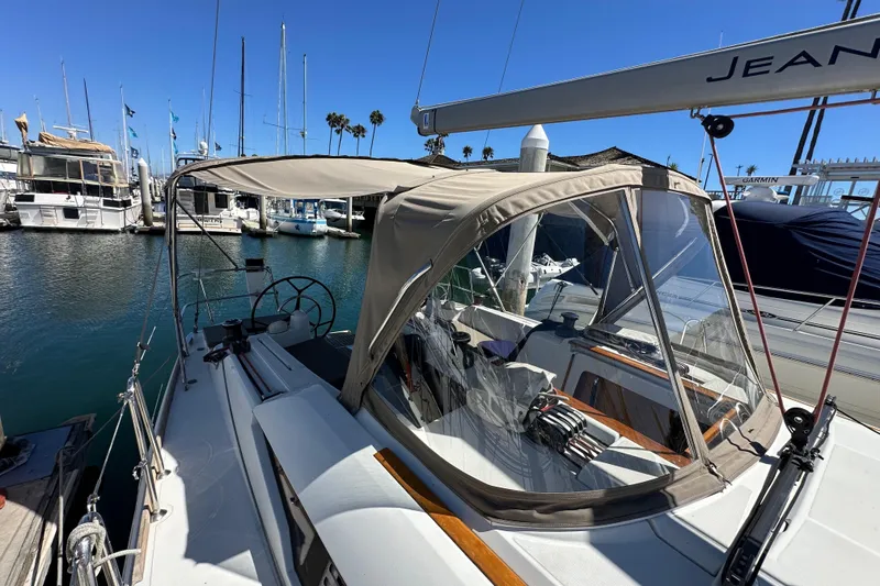 Slide: The Image of 2015 Jeanneau Sun Odyssey 409 sailboat docked in a marina under clear blue skies. - 23