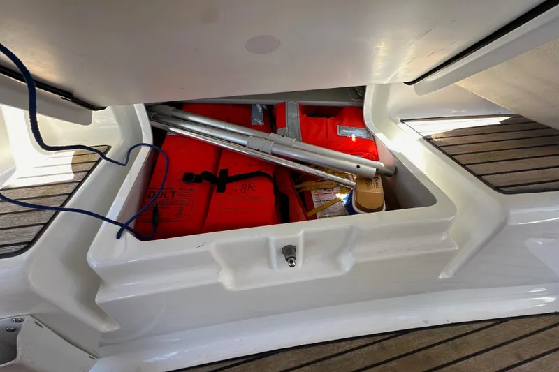 Slide: The Image of Storage compartment on 2015 Jeanneau Sun Odyssey 409 with life jackets and equipment. - 37