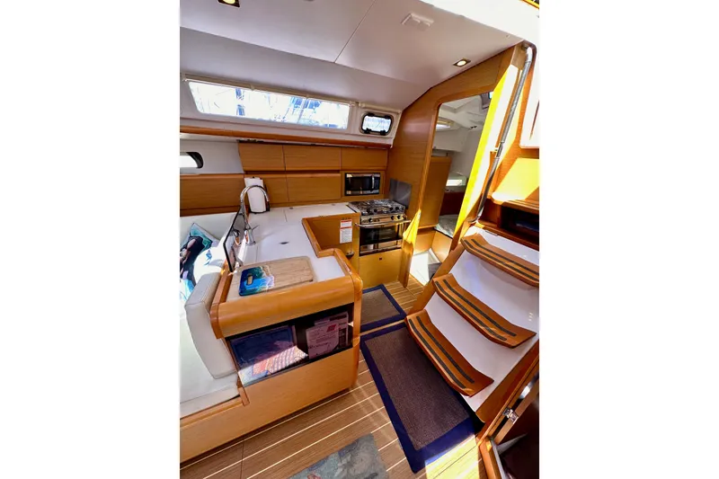 Slide: The Image of Interior of 2015 Jeanneau Sun Odyssey 409 sailboat with modern kitchen and wooden finishes. - 43