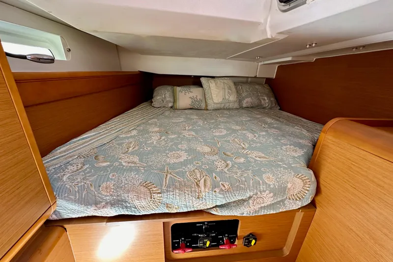 Slide: The Image of Cozy cabin interior of 2015 Jeanneau Sun Odyssey 409 sailboat with patterned bedding. - 48