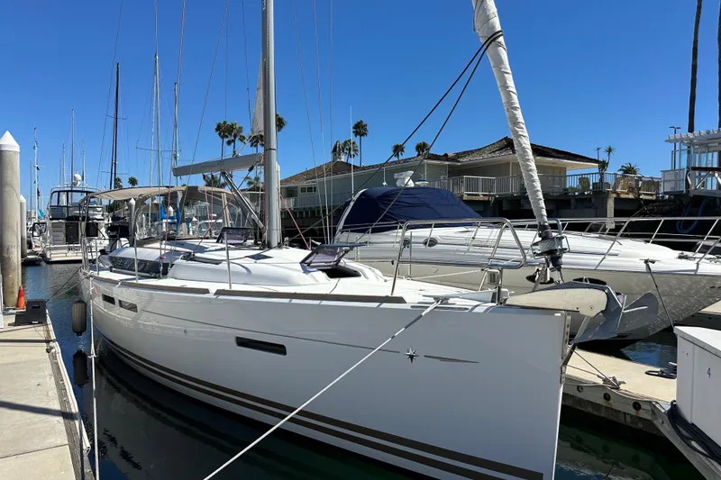 Slide: The Image of 2015 Jeanneau Sun Odyssey 409 sailboat docked at marina under clear blue sky. - 5
