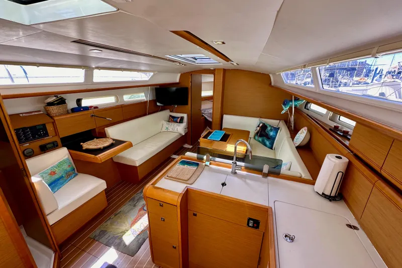 Slide: The Image of Interior of 2015 Jeanneau Sun Odyssey 409 yacht with modern furnishings and ample natural light. - 51