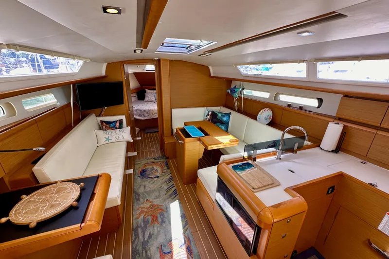 Slide: The Image of Luxurious interior of 2015 Jeanneau Sun Odyssey 409 sailboat, featuring modern wood finishes and cozy seating. - 57