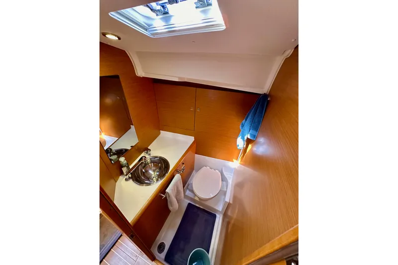 Slide: The Image of Bathroom interior of 2015 Jeanneau Sun Odyssey 409 yacht, featuring sink and toilet. - 67