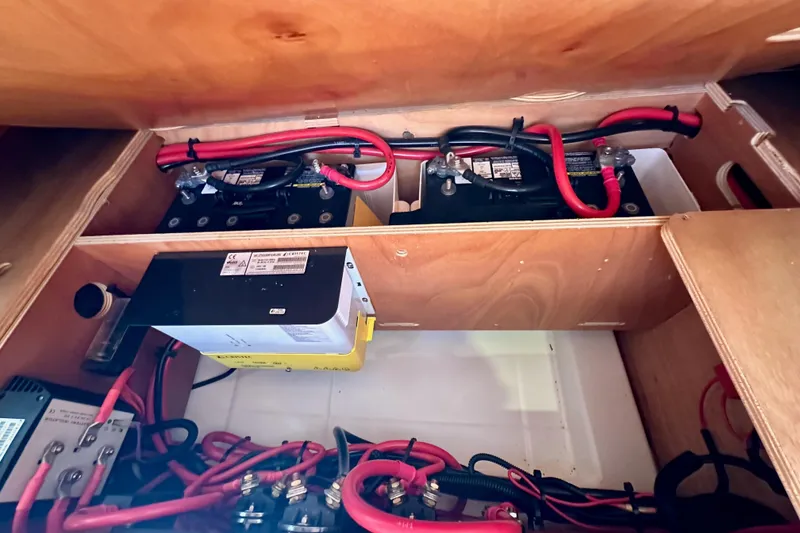 Slide: The Image of Battery compartment of 2015 Jeanneau Sun Odyssey 409 sailboat, featuring wiring and electrical components. - 75