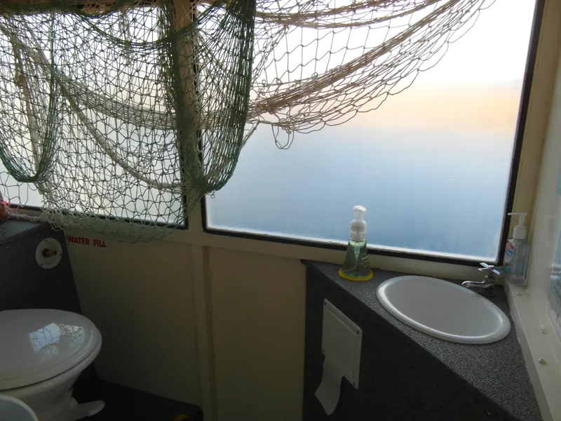 Slide: The Image of Bathroom interior of 2005 Trident 40 Passenger Tour Boat with nautical decor. - 12