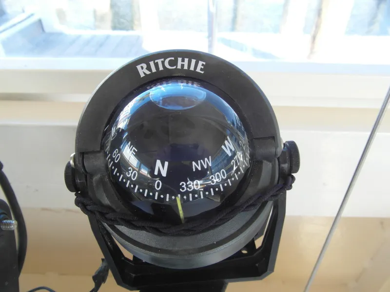 Slide: The Image of Ritchie compass on Trident 40 Passenger Tour Boat, 2005 model, showing navigation directions. - 17