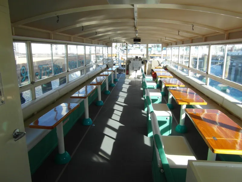 Slide: The Image of Interior of a 2005 Trident 40 Passenger Tour Boat with seating and tables. - 3