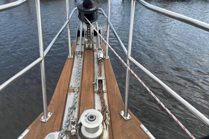 Slide: The Image of Bow of 1995 Island Packet 37 sailboat with anchor chain and winch. - 10