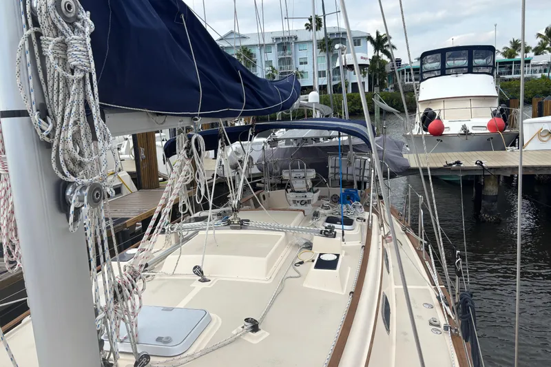 Slide: The Image of 1995 Island Packet 37 sailboat docked at marina with rigging and deck view. - 13
