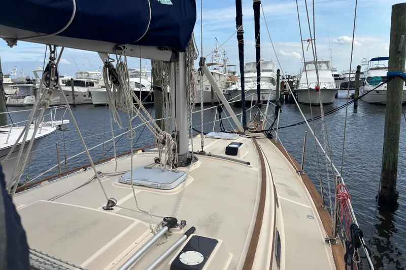 Slide: The Image of 1995 Island Packet 37 sailboat docked at marina with other boats. - 14