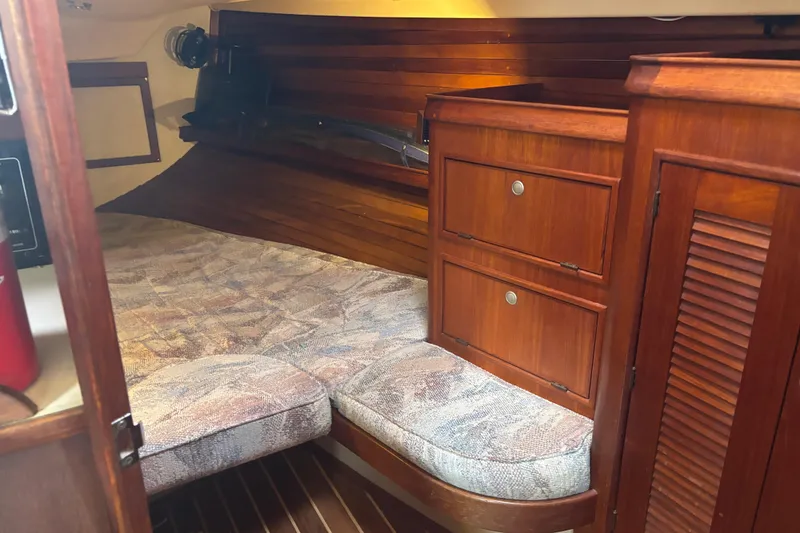Slide: The Image of Cozy cabin interior of a 1995 Island Packet 37 sailboat with wooden cabinetry. - 17