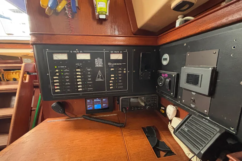 Slide: The Image of Control panel of a 1995 Island Packet 37 yacht, featuring various gauges and switches. - 23