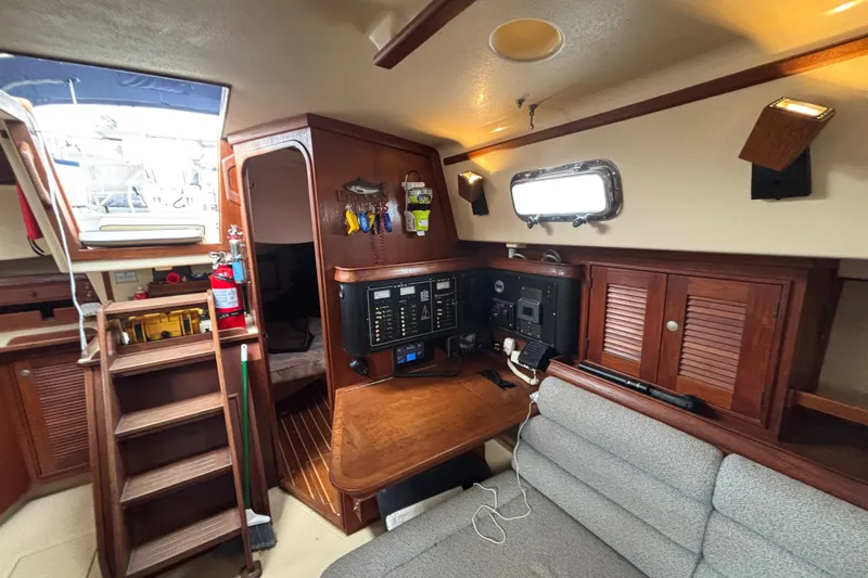 Slide: The Image of Interior of 1995 Island Packet 37 sailboat with navigation station and wooden cabinetry. - 24