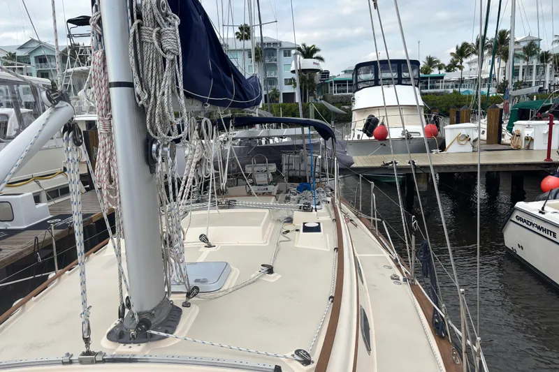 Slide: The Image of 1995 Island Packet 37 sailboat docked at marina with other boats. - 6
