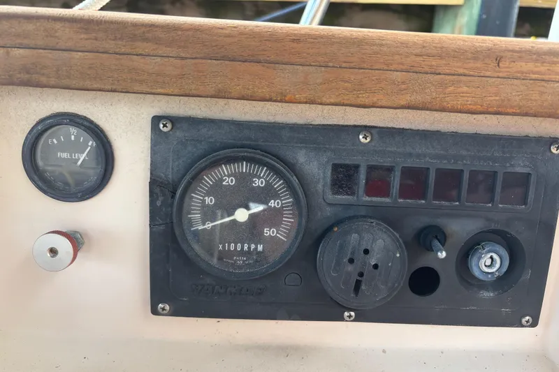 Slide: The Image of Control panel of a 1995 Island Packet 37 sailboat with fuel and RPM gauges. - 8