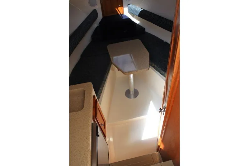 Slide: The Image of 2005 Albemarle 280 Express Fisherman cabin interior with seating and table. - 10