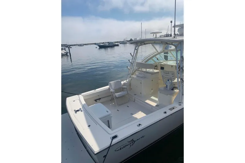 Slide: The Image of 2005 Albemarle 280 Express Fisherman boat docked in a serene marina setting. - 3