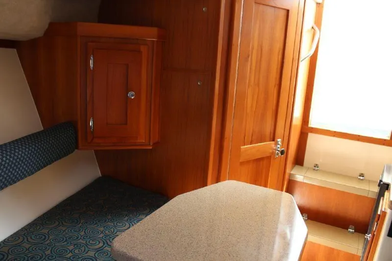 Slide: The Image of Interior of 2005 Albemarle 280 Express Fisherman with wood cabinetry and seating. - 9