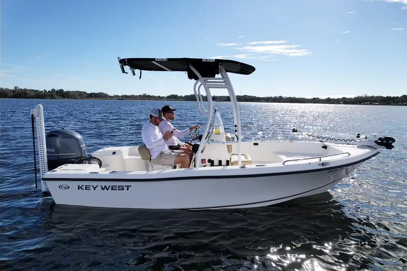 The Image of 2019 Key West 176 Center Console boat on a sunny lake with two passengers. - 0