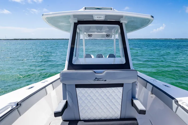 Slide: The Image of 2025 Streamline R 35 boat on clear blue water, showcasing sleek design and luxury seating. - 18