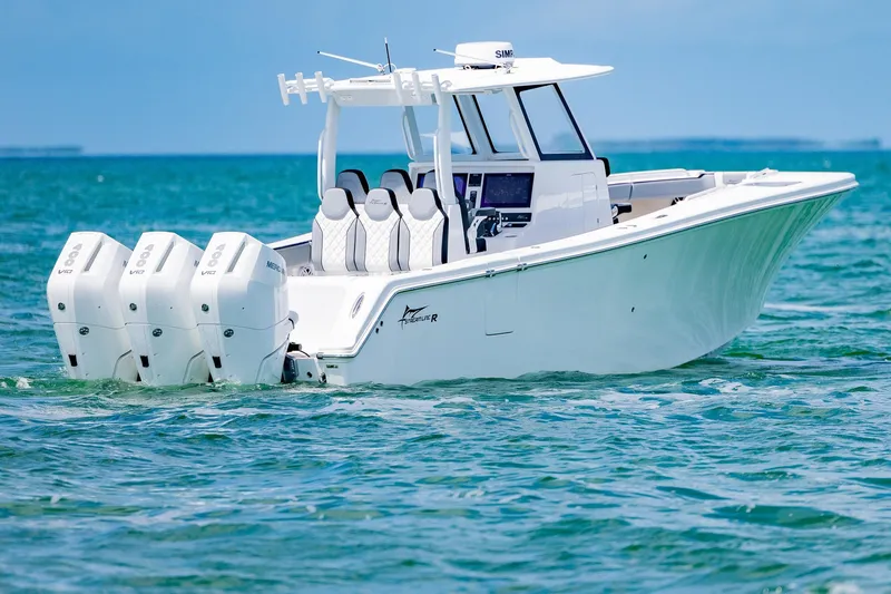 Slide: The Image of 2025 Streamline R 35 boat with triple outboard engines on clear blue water. - 2