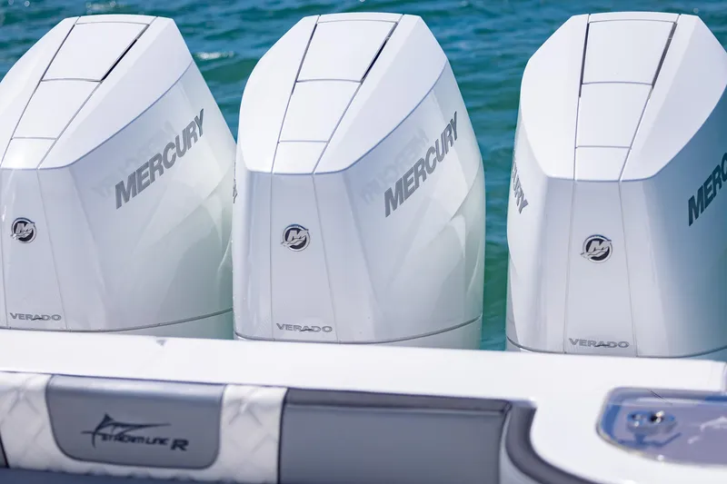 Slide: The Image of Triple Mercury Verado engines on a 2025 Streamline R 35 boat in the water. - 35