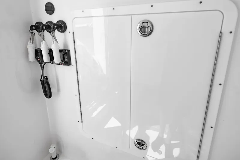 Slide: The Image of 2025 Streamline R 35 boat interior with storage compartment and hanging accessories. - 40